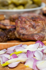 Onions, grilled or barbecued meat and pickled gherkins