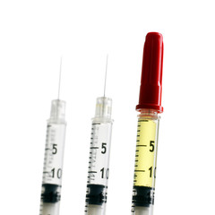 three syringes isolated on white