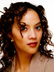 Naklejka premium Young hispanic woman in brown sweater portrait