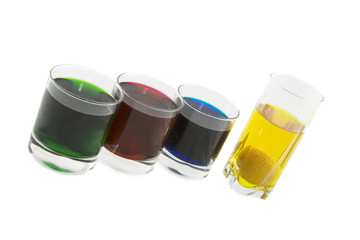 Four glasses with multi-coloured cocktails isolated over white b