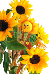 Fabric scarecrow together  sunflowers and ears of wheat