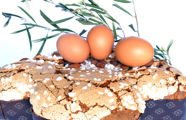 Colomba with fresh eggs and olive twig on white
