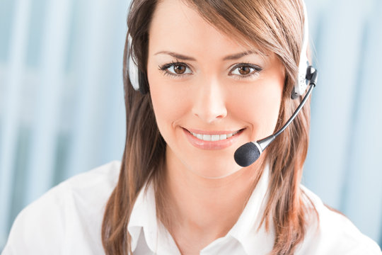 Portrait of happy support phone operator in headset