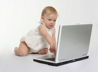 little girl pressing the button on the laptop