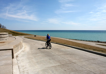 Cyclist riding downhill to lake