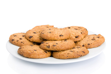 Pile of chocolate chip cookies on a dish isolated