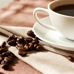 Cup of coffee with coffee beans