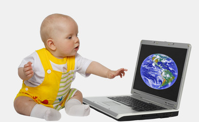 little girl touching screen on the laptop