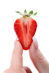 Fresh strawberries in fingers
