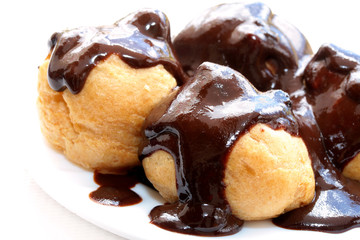 Fresh profiteroles with hot chocolate sauce.