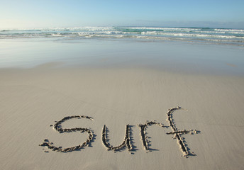 Surf written on a tropical beach