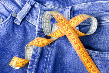Measuring tape against the backdrop of jeans