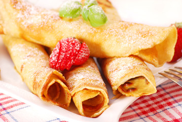 rolled pancakes with powder sugar and  strawberry