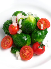 Fototapeta na wymiar Fresh organic salad of Brussel sprouts and cherry tomatoes