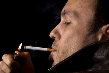 Fototapeta premium Young man smoking a cigarette
