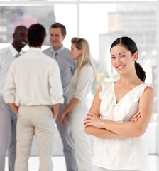 Attracive businesswoman in front of a group of associates