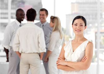 Attracive businesswoman in front of a group of associates