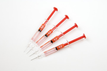 group of four red needles