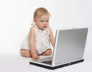 little girl looking on the laptop