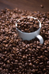 White cup full of coffee beans