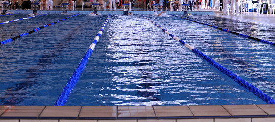 A new lap for teens during playoff in a indoor swimming pool