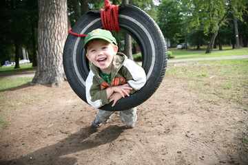 Young Boy in Tire Swing