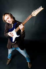 Obraz premium Young man playing electro guitar