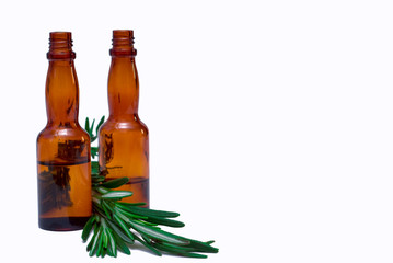 Oil for the body with a sprig of rosemary