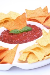 Nachos and salsa dip in a bowl