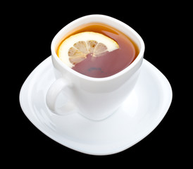 cuppa with lemon and saucer on black