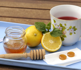 Cup of tea with lemon honey and herbs