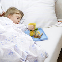 Young girl lying in bed with flu
