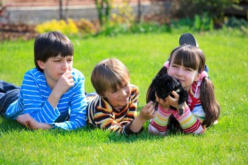 Children playing with dog