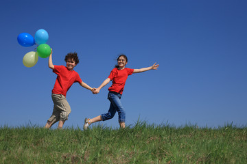 Kids holding balloons ,playing outdoor