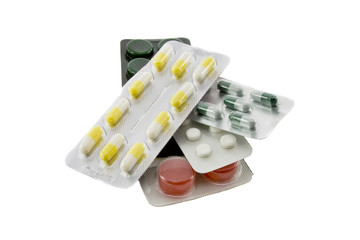 Many different color tablets and pills isolated over white backg