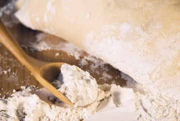 spoon of flour and dough on the table