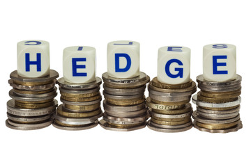 Stacks of coins with the word HEDGE isolated on white background