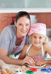 Mother and daughter in Kitchen Smiling at Camera