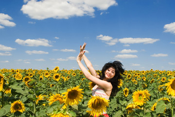 Naklejka na ściany i meble fun woman in the field of sunflowers