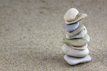 Balancing pebbles placed on sand