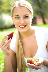 Woman eating strawberries