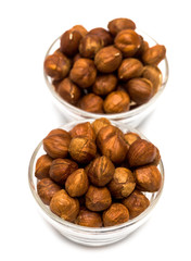 many hazelnuts in glass bowls