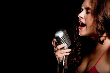 Beautiful singer singing with microphone