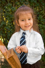 Young boy with long hair in white shirt and tie