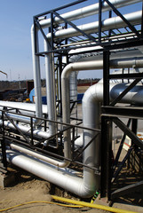 industrial pipelines on pipe-bridge against blue sky