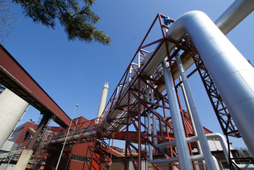 industrial pipelines on pipe-bridge against blue sky