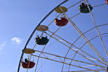 Big wheel on a background of the blue sky