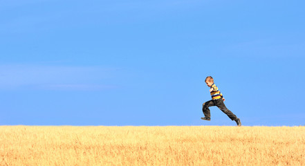 Young boy jumping on field