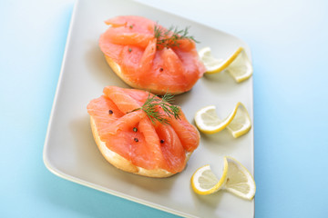 Smoked salmon on bagel with fresh black pepper.