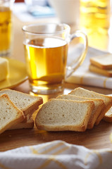 Sliced double baked bread with tea for breakfast